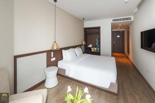 Postel nebo postele na pokoji v ubytování Apec Beach Mui Ne Resort