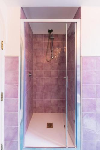 a shower with pink tiles in a bathroom at Villa Cortile Mastro Francesco Ravello centre Amalfi Coast in Ravello