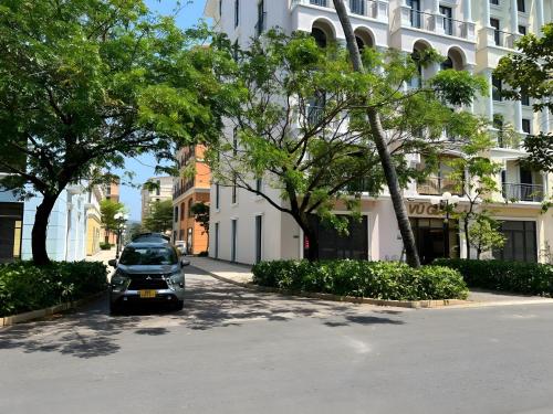 a car parked in a parking lot in front of a building at Vũ Gia Phú Quốc Hotel in Phu Quoc
