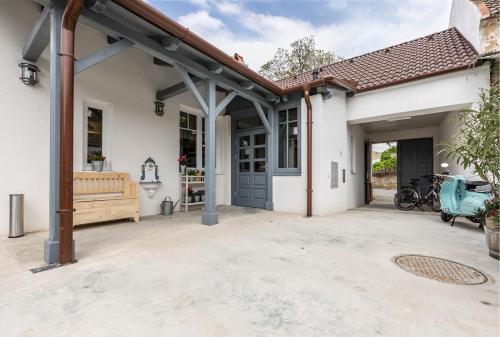 a white house with a garage and a driveway at Ferienhaus Burgenland 2 in Mönchhof