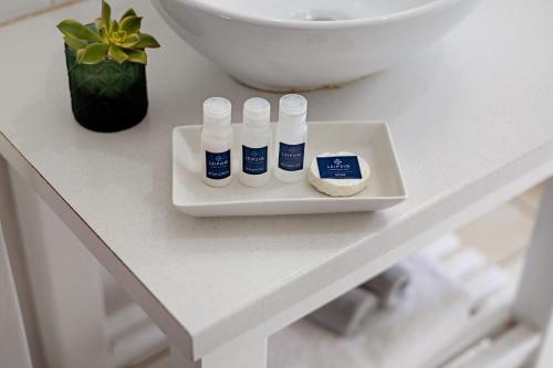 a white counter with four bottles ofodorizers on a table at Leipzig Country House & Winery in Nuy