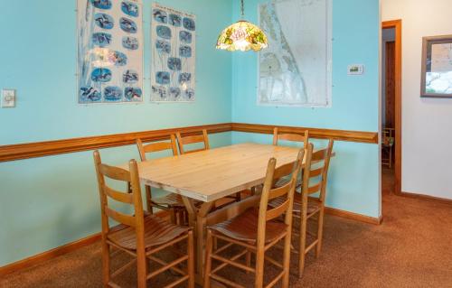 a dining room with a wooden table and chairs at PS-I -Swan Sea in Duck