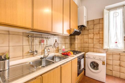 a kitchen with a sink and a washing machine at Finally in Rome in Rome
