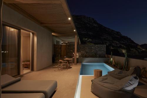 a house with a swimming pool at night at ADĀMA - A Signature Collection by Zálo Spaces - Adults Only in Matala