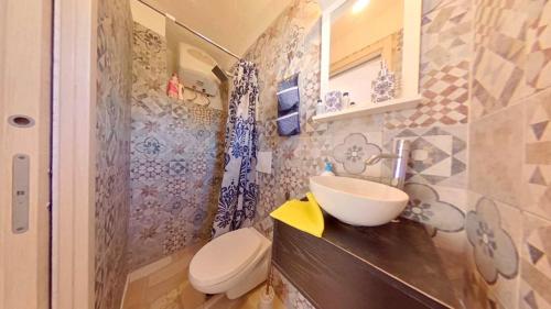 a bathroom with a sink and a toilet at i trulli di Holly in Selva di Fasano