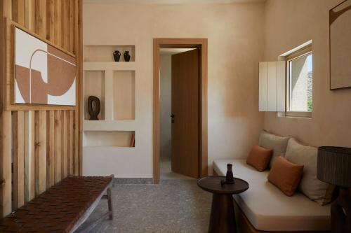 a living room with a couch and a window at ADĀMA - A Signature Collection by Zálo Spaces - Adults Only in Matala