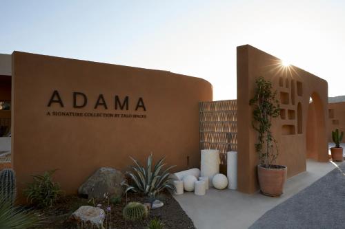 a building with a sign that reads adamaeaartifactsartifactsartifactsbestosbestosbestosbestos at ADĀMA - A Signature Collection by Zálo Spaces - Adults Only in Matala