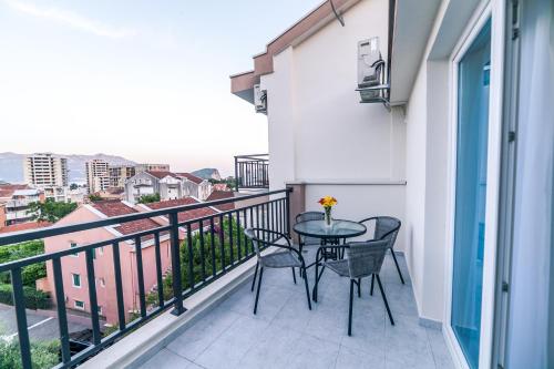 a balcony with a table and chairs on it at Milara Apartments in Budva