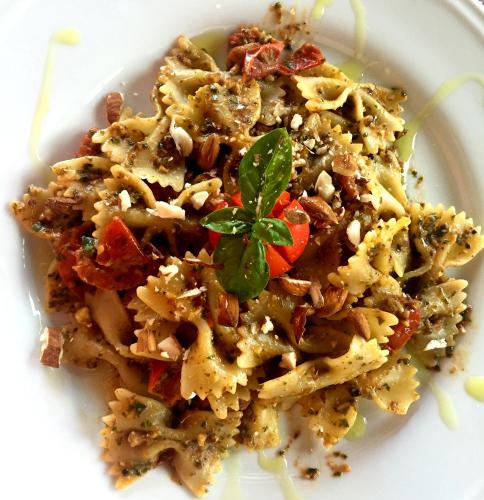 a plate of food with pasta with a garnishment at Agriturismo La Casa di Bacco in Agrigento