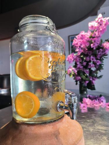 a glass jar filled with water with orange slices in it at Omir Bed & Breakfast in Pula