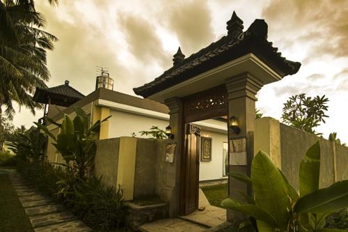 a house with a gate and a fence at Ubud Lestari Villa in Ubud
