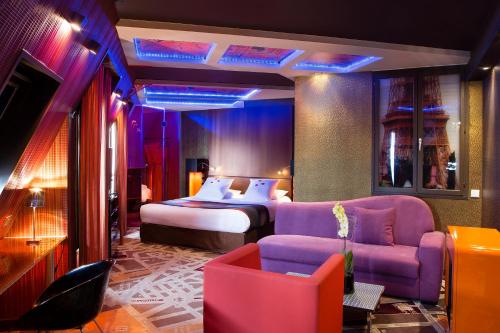 a hotel room with a bed and a purple couch at Residence Paris Eiffel in Paris