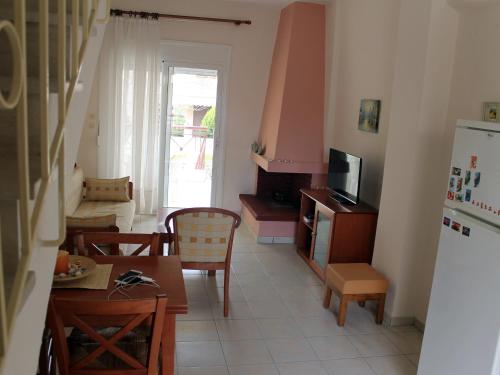 a kitchen and dining room with a table and a refrigerator at Siviri Rental Houses in Siviri