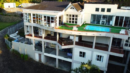 an aerial view of a white building with a swimming pool at LookOut Ramsgate in Ramsgate