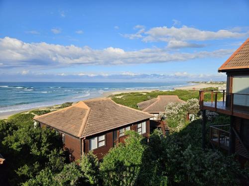 a view of a house and the beach at Sandpiper 7 - Cozy Oasis in Jeffreys Bay
