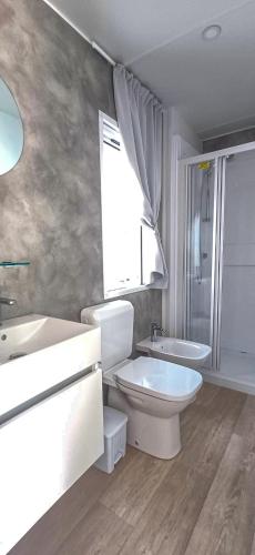 a bathroom with a toilet and a sink and a shower at Romea Family Camping in Casal Borsetti