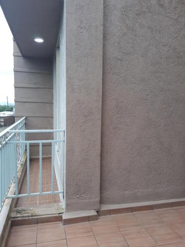 a balcony with a metal railing on a building at Spanish villa , chinchoti in Bapane