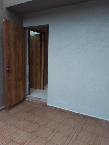 an empty room with a door and a wooden floor at Spanish villa , chinchoti in Bapane