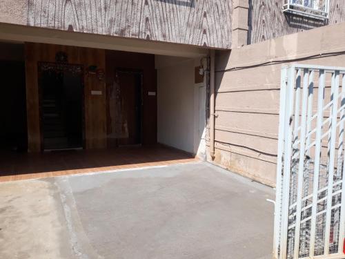 an open door of a building with a gate at Spanish villa , chinchoti in Bapane