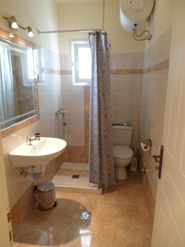 a bathroom with a sink and a toilet at Rosa's Studios in Fiskardo