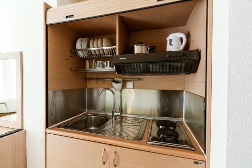 a kitchen with a sink and a stove at Stefanidis studios in Stavros