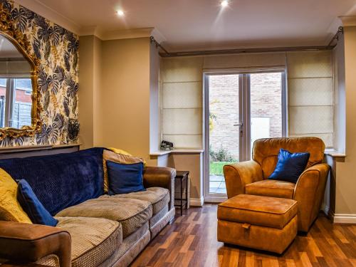a living room with a couch and two chairs at Coopers Townhouse - Cottage in Worle