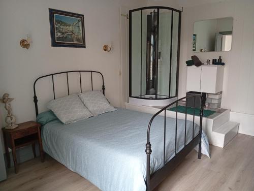 a bedroom with a bed and a mirror at L'immeuble de Didier et Fabien in Guînes