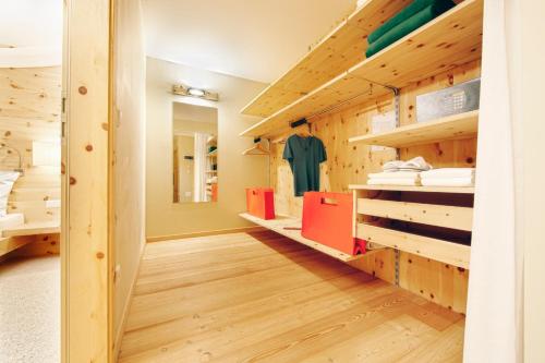 a room with wooden floors and wooden shelves at Arosea Life Balance Hotel in Santa Valburga St. Walburg