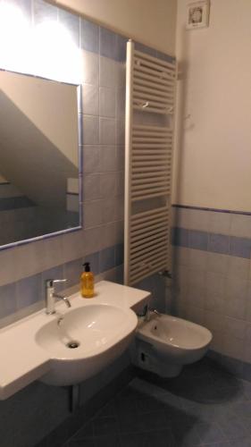 a bathroom with a sink and a toilet and a mirror at Capanna 1826 in San Gimignano