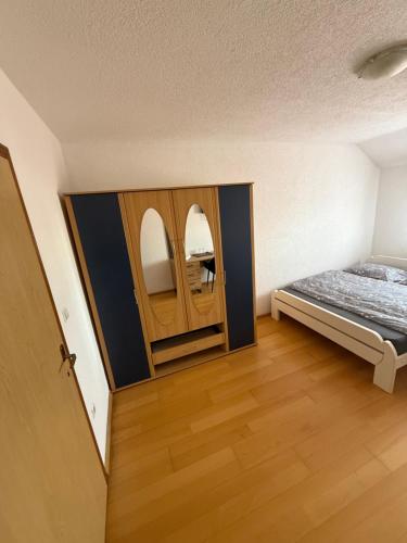 a room with a bed and a cabinet with two mirrors at Motel Napoleon in Velika Kladuša