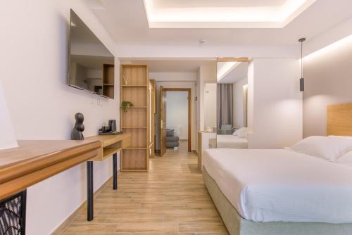 a hotel room with a bed and a desk at Archontiko Liamas in Stavros