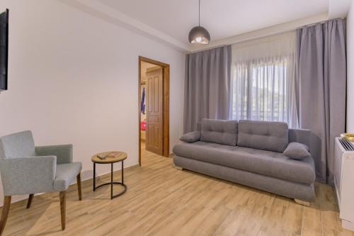 a living room with a couch and a table and chairs at Archontiko Liamas in Stavros