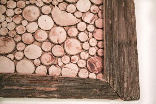 a painting of a pile of wood in a frame at Oberachen Apartment in Ellmau