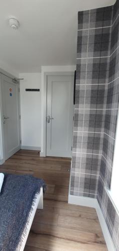 a bedroom with a wall with a checkeredkered at Pasta Factory Guest Rooms in Galway