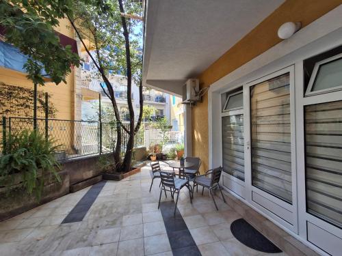 a patio with chairs and a table on a balcony at Apartmani Kojovic in Igalo