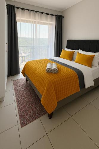 a bedroom with a large bed with two towels on it at Lowveld Getaway in Nelspruit