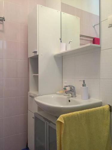 a bathroom with a sink and a mirror at Apartment Maestral in Rogač