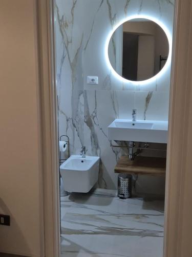 a bathroom with a sink and a mirror at Casa Baia Tramonto in Patù