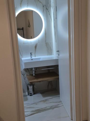 a bathroom with a sink and a mirror at Casa Baia Tramonto in Patù