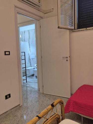 a room with a door leading to a room with a table at Casa Baia Tramonto in Patù