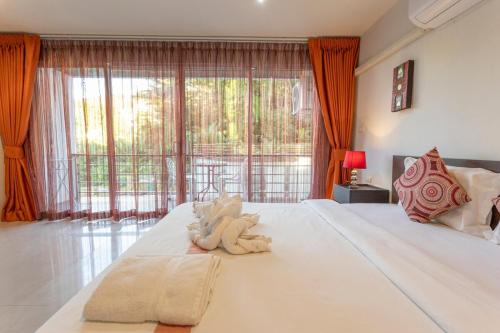 a bedroom with a bed with a stuffed animal on it at C134 Condo 1BR in Heart of Patong Pool, Beach, Bangla in Patong Beach