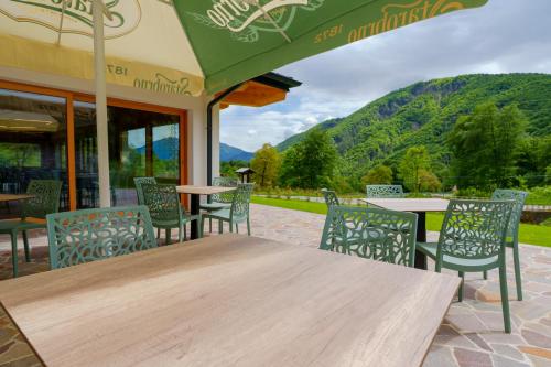 a wooden table and chairs on a patio at Albergo ariaPura Ristorante 