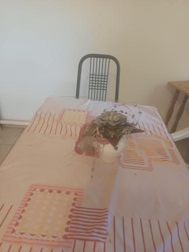 a bed in a room with a table and a chair at Tapolcai Tóparti Fészek in Tapolca
