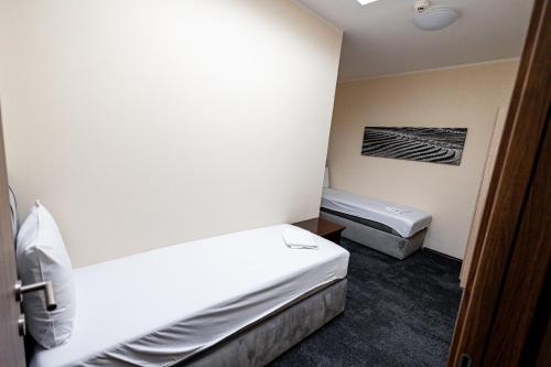 a small room with two beds and a sink at Agape Villa Apartments in Novi Sad