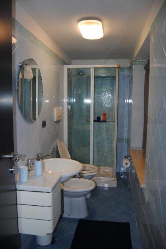 a bathroom with a toilet and a sink and a shower at Il Susino in Tirrenia