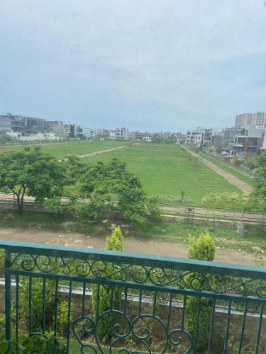 a view of a green field from a balcony at IT City Homestay-Secure & Comfortable Stay in Mohali in Mohali