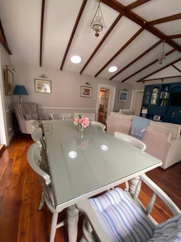 a dining room with a table and chairs at 1800's Cosy Cottage in Dungarvan in Balnacart