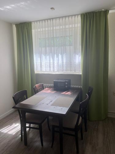 a dining room with a table and chairs and a window at Dünenhaus Souterrain2 in Timmendorfer Strand