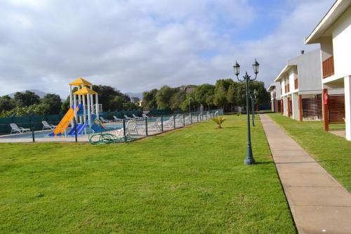 a park with a playground and a slide at Cabañas Las Añañucas V in La Serena