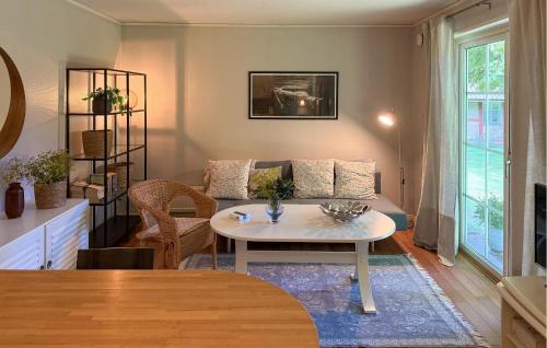 a living room with a table and a couch at 1 Bedroom Beautiful Home In Gantofta in Gantofta